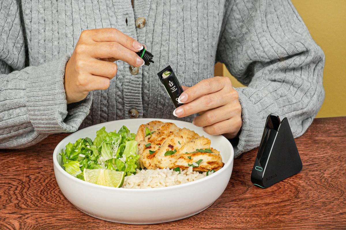 Person feeling unwell at a restaurant table after eating a gluten-free meal